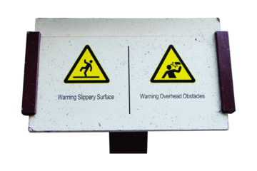 Sign warning No Climbing isolated on cut out PNG or transparent background. White plastic sign with red letters and a fence climber icon attached to cave wall. Safety of life and property.