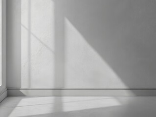 Minimalist interior with soft light and shadows on a blank wall, highlighting a serene atmosphere in a modern space for design inspiration.