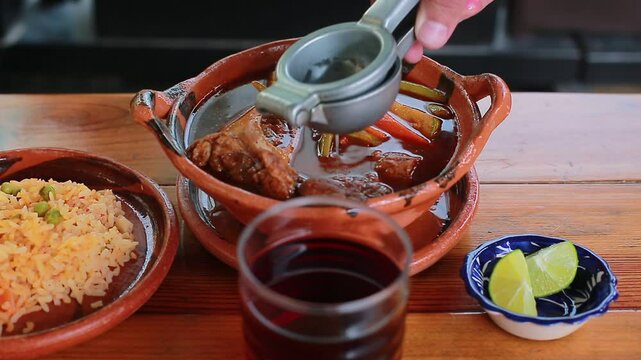 Add lemon to the Mole de Olla accompanied with rice
