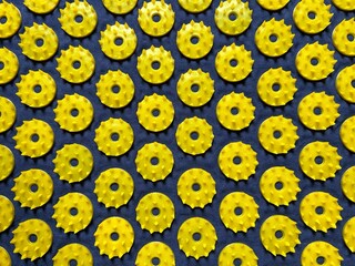 Close-up of a textured acupressure mat with yellow spiked discs designed for pain relief, muscle...
