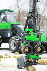 Powerful Green Logging Machine in Action During Snowy Winter Day - Modern Forestry Equipment