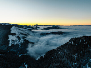 Winter hiking to Sina in Low Tatras National park near jasna is full of beautiful views. Sunset in Slovakia mountains with Chopok peak.