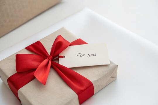 red ribbon gift box with for you card. Elegant personalized present