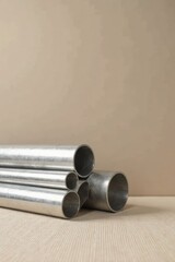 Close-up view of various metal pipes and tubes neatly arranged on a textured surface