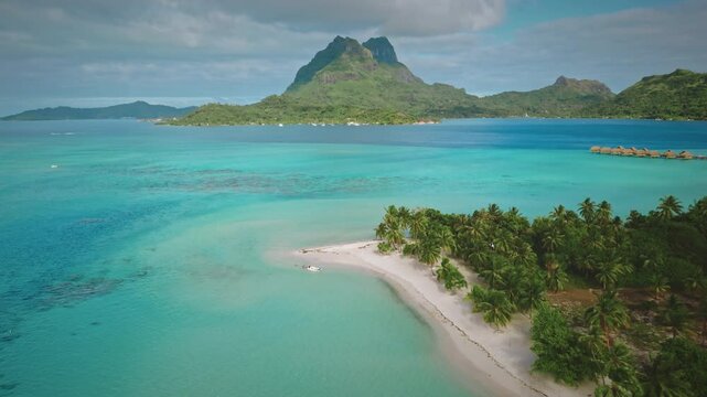 Breathtaking aerial view of Bora Bora in French Polynesia, featuring turquoise waters, lush greenery, iconic mount Otemanu, and luxurious overwater bungalows. Travel tropical vacation concept
