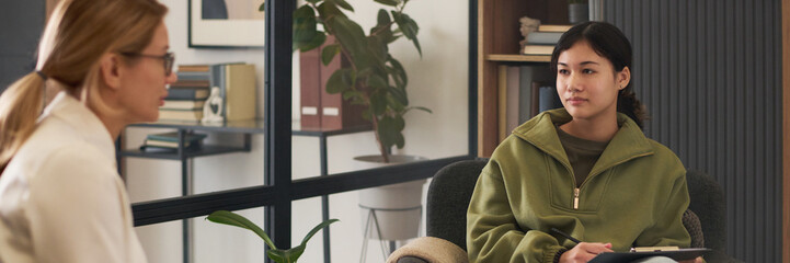 Header image of teenage girl listening to psychologist during support therapy session for youth