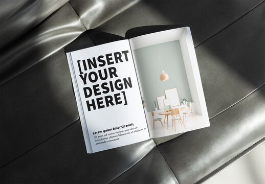Mockup of An open book rests on a sleek surface, showcasing two blank pages, ready for notes or sketches.