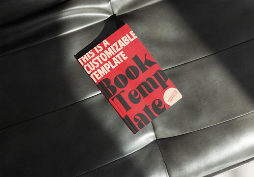 book cover mockup rests on a stylish gray surface, illuminated by soft light, perfect for showcasing designs.
