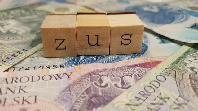 Polish PLN banknotes and ZUS inscription made of letter cubes. Social Insurance Institution