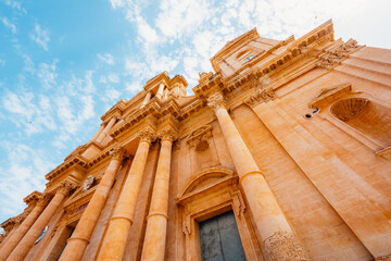 view in Noto, with the Basilica Minore di San Nicolo and Palazzo Ducezio, Sicily, Italy.
