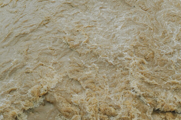 Strong current in the river, waters turned muddy after heavy autumn rains.