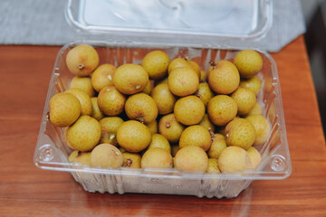 Kelengkeng or longan fruit, one of tropical fruit that has sweet taste, served in a plastic box.