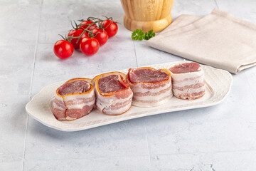 Raw pork tenferloin with bacon