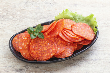 Sliced pepperoni sausage in the bowl