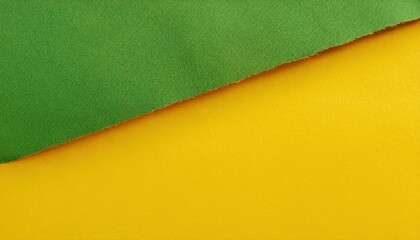 Fototapeta premium torn edge of yellow paper over green background creating diagonal division, minimalist abstract design for modern background