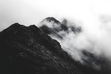 Fog descends on mountain peak