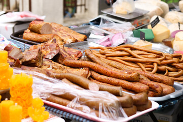 traditional market or fair where meat and dairy products are sold. In the photo, smoked sausages, meat and cheese. Home production.gastronomic tour.farmer's market. High quality photo