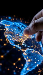 Fingertip touching illuminated North America on a digital globe