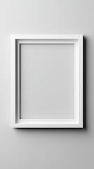 Empty Frame: A pristine white picture frame hangs on a soft gray surface, casting a gentle shadow and inviting the viewer to imagine their own art or memories within.