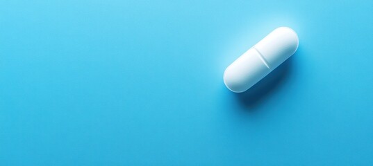 Examining the effects of a white capsule laboratory setting medical content bright blue background close-up perspective health awareness