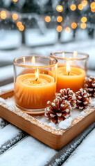 Snowy winter scene with lit candles and pine cones