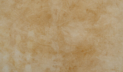 Close-up of beige textured fabric, Canvas for cross stitching or other handicrafts. Soft and warm color tones create a vintage, rustic aesthetic. Natural brown linen texture fabric background.