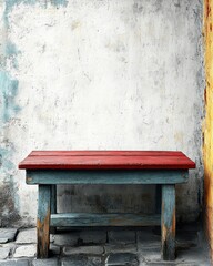 A vibrant red bench is positioned in front of a clean, white wall, creating a striking contrast. The bench's smooth surface invites relaxation, while the wall adds a minimalist backdrop.