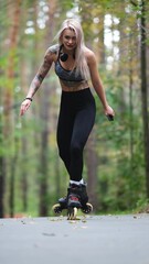 Attractive blonde feels free and light while rollerblading in city park in summer. Stunning...