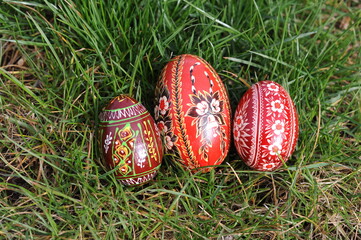 Traditional hand-dyed and hand-painted Easter eggs on the green grass in Poland called pisanka or kroszonka or kraszonka