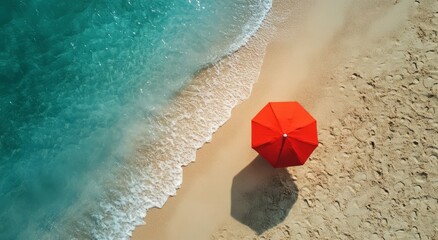 Naklejka premium Ocean Waves and Sandy Shore with a Vibrant Umbrella