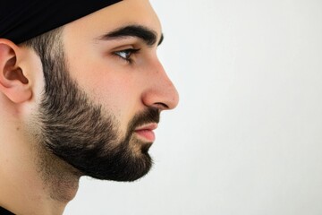 Fototapeta premium Minimalistic portrait close-up of a middle eastern man with beard