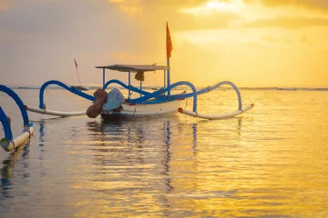 Fotobehang Oranje Sanur beach is a coastal stretch of beach east of Denpasar in southeast Bali, and a lot of traditional fishing boats(spider boat), is one of the famous tourist beaches on the island of Bali   © Rungsilp