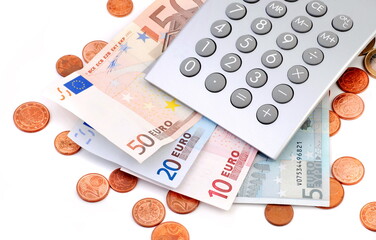 Euro banknotes and coins with calculator.