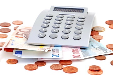 Euro money, banknotes and coins with calculator, isolated on white.