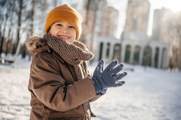 Child enjoying a snowy day at the playground wearing winter clothing