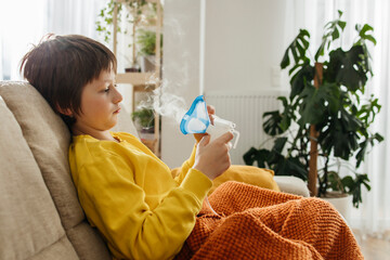 Child using a nebulizer for inhalation therapy at home