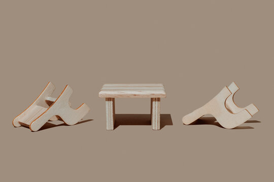 Toy wooden table and chairs on the floor representing a breakup or fight