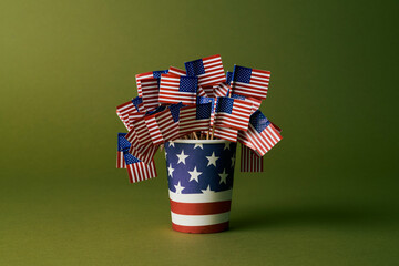 Disposable cup with American flags in a studio setting symbolizing patriotism