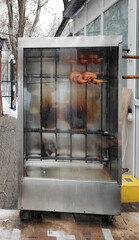grilled chicken in an outdoor oven on a rotisserie