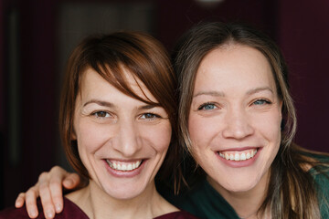 Portrait of two smiling women entrepreneurs in a massage studio