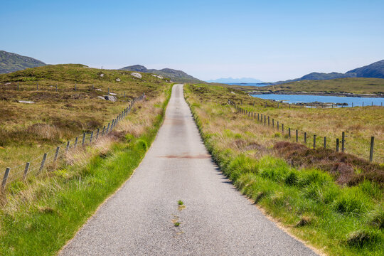 Road leading through the wild landscape of South Uist in the Western Isles, Scotland