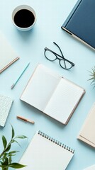 Workspace Essentials: An overhead shot presents a clean and organized workspace with a cup of coffee, an open notebook, eyeglasses, pens, and other stationary on a soft-blue backdrop.
