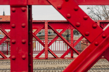 Close-up of a red riveted bridge in Wroclaw, showcasing early 20th-century architecture