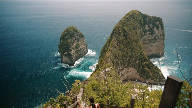 Woman descending stairs to Kelingking Beach Nusa Penida