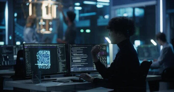 Asian Researcher Making a Quantum Computing Experiment, Monitoring Live Artificial Intelligence Data on Computer Screen, Running Software Code in Terminal Window. Developer Solving a Problem
