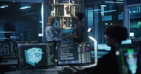 Engineers Developing a New Approach to Solve a Computational Problem with a Powerful Quantum Processor. Focus Switching From Male and Female to a Developer Working on a Desktop Computer