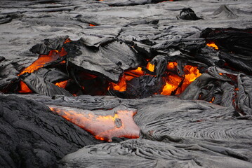 Hot magma flows  over old lava field