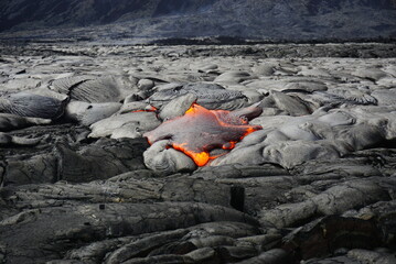 Hot magma flows  over old lava field