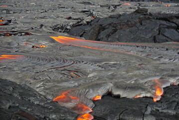 Hot magma flows  over old lava field