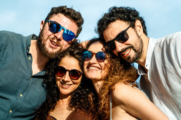 Happy group of friends wearing sunglasses enjoying summer together